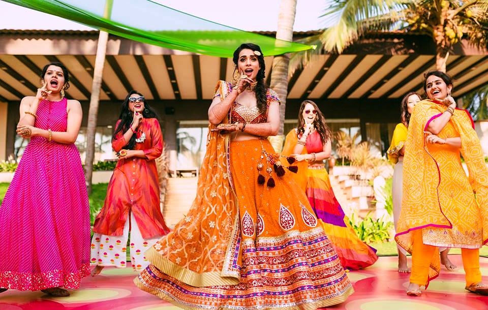 Family and friends performing a lively dance during a well-organized Sangeet function by Gaur Wedding Decor.