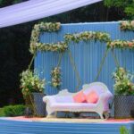 Modern hexagon iron stage decor with sleek metallic frames and vibrant floral accents, ideal for contemporary weddings.