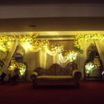 Elegant cream and golden stage decor with mirror console.