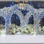 Elegant blue hydrangea arch stage decor with delicate floral arrangement for weddings and events.