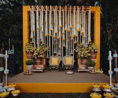 Haldi decoration in Delhi with yellow marigold flowers and vibrant backdrop